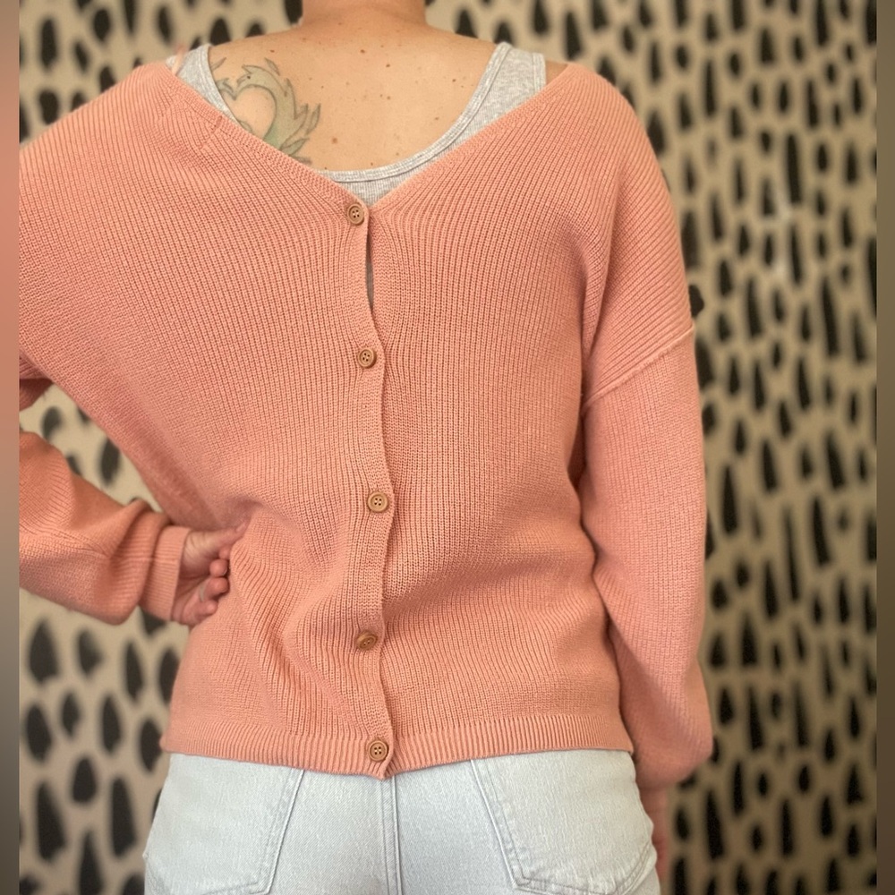 Pink sweater with button up detail in back